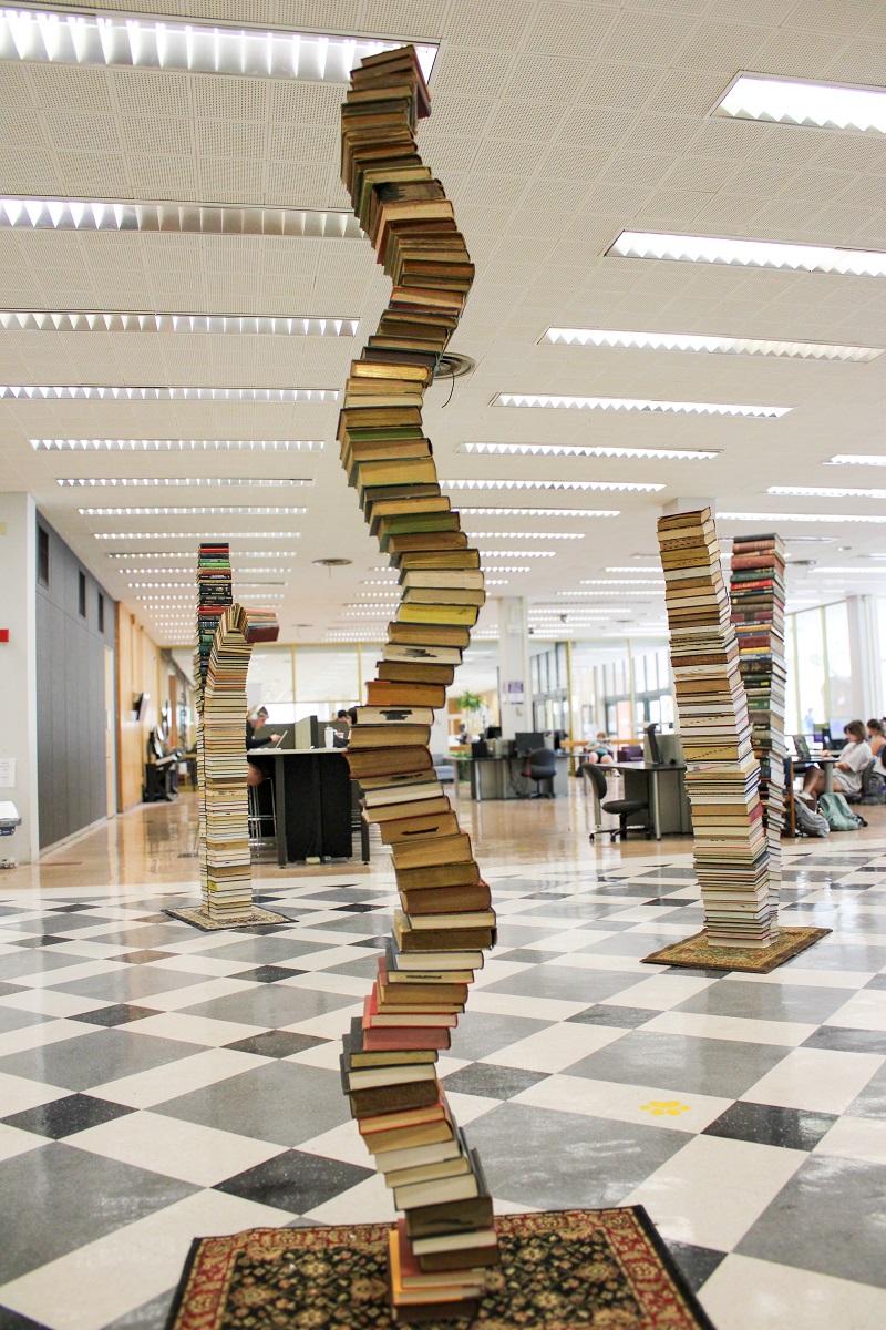 a tall, curving stack of books