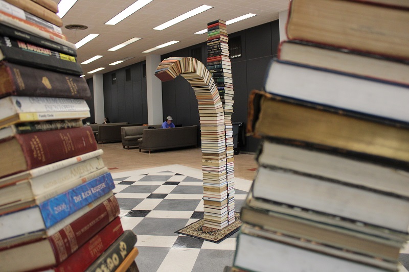 two stacks of books. One stack is straight and the other is curved.