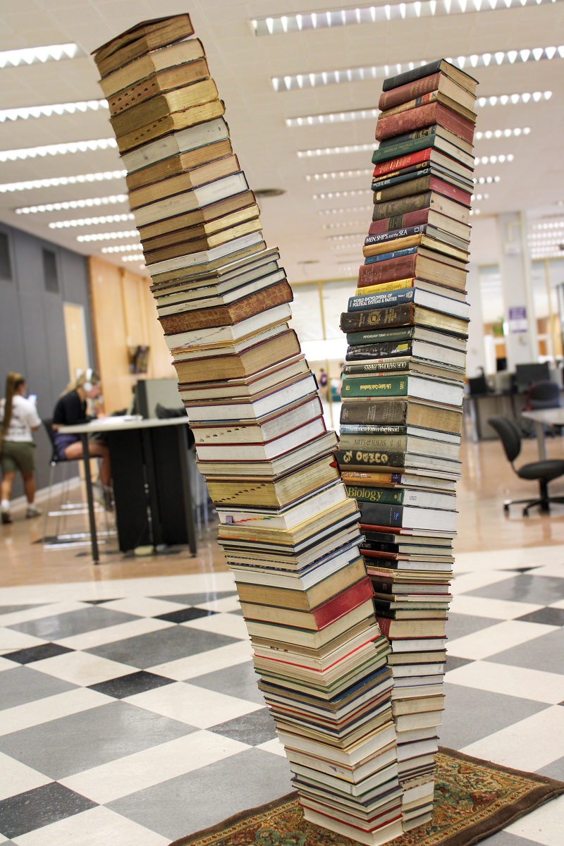 two stacks of books in the shape of a V