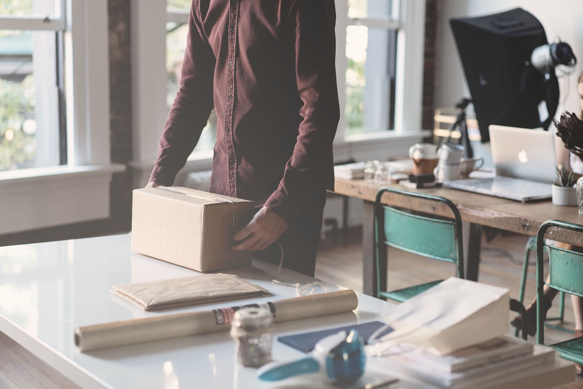 Person packing a box.