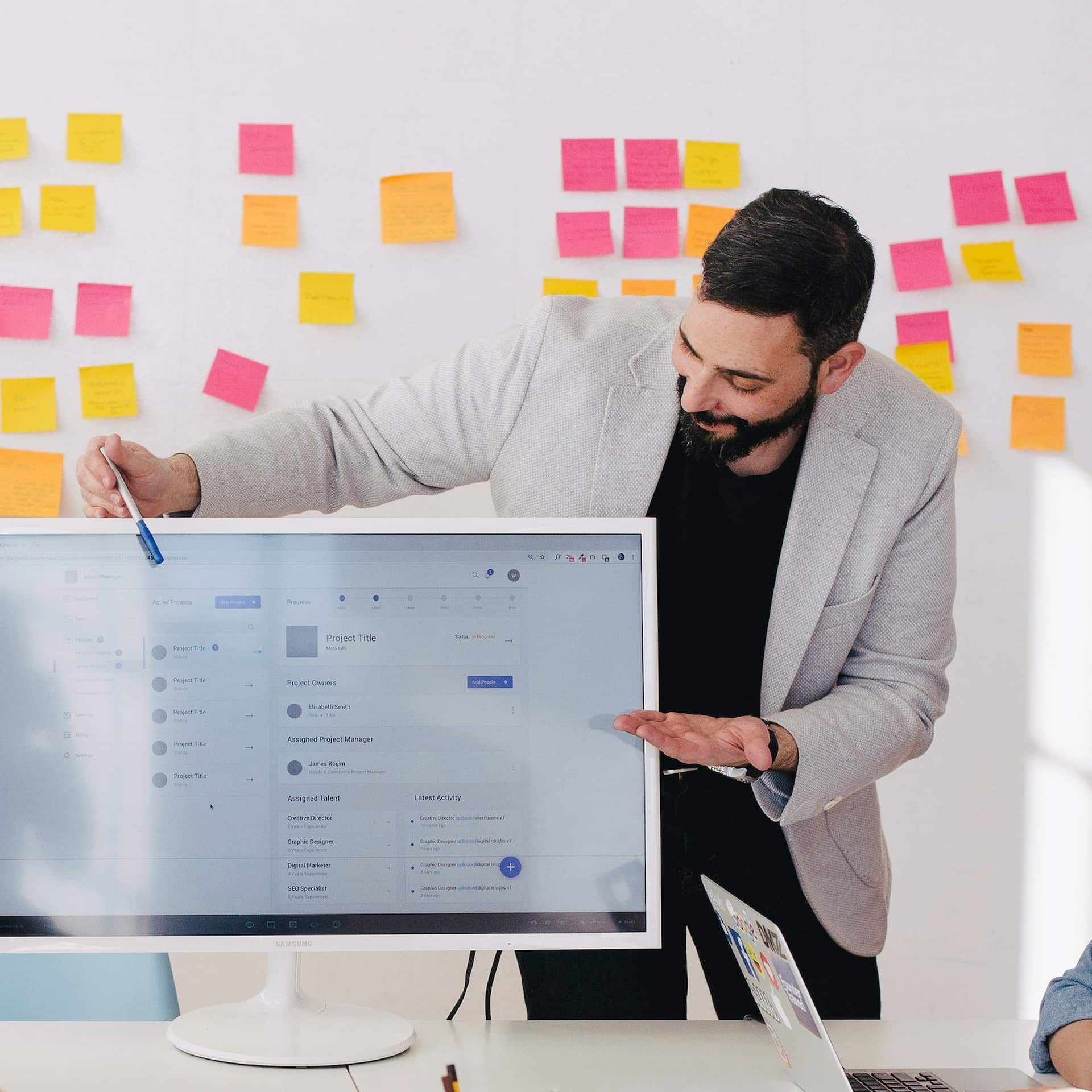 Man pointing at large monitor