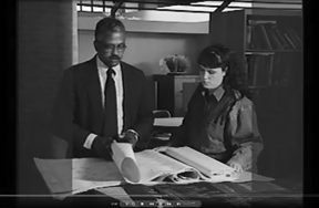 Julian T. White and student review architectural plans