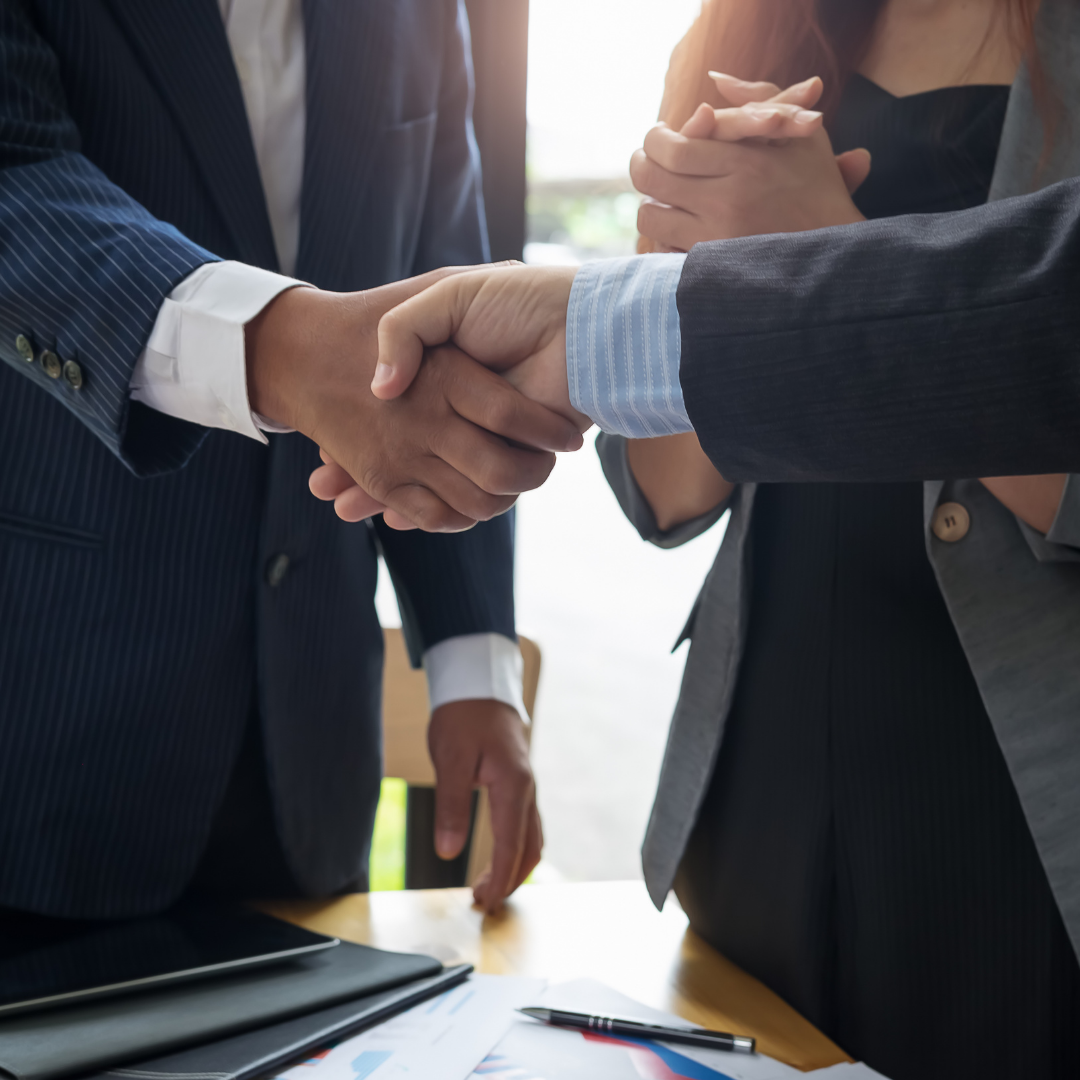 two people in business attire shake hands