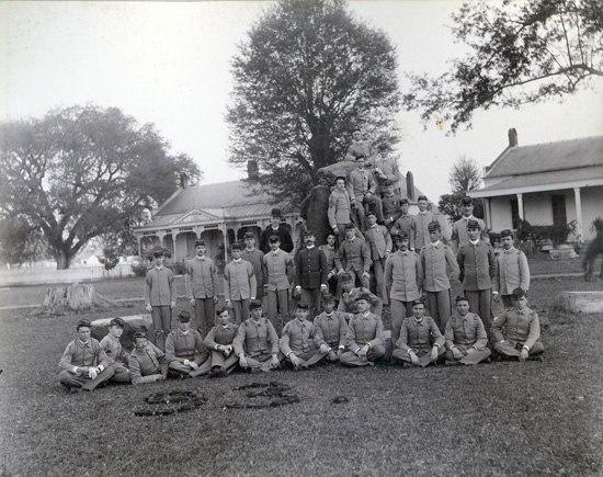 The Class of 1893 on the downtown campus. In the back ground are the homes of the treasurer (left) and commandant of cadets (right).