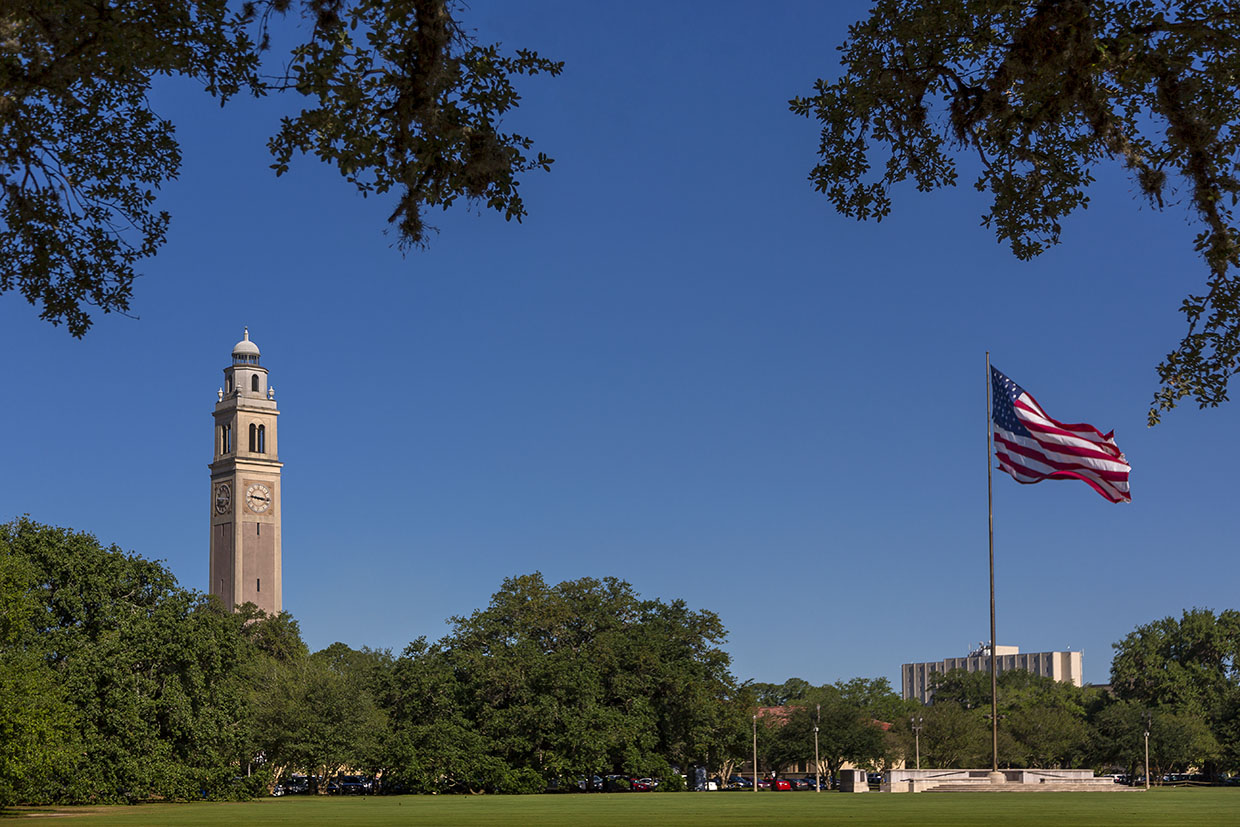 LSU Memorial Tower and American flag flying