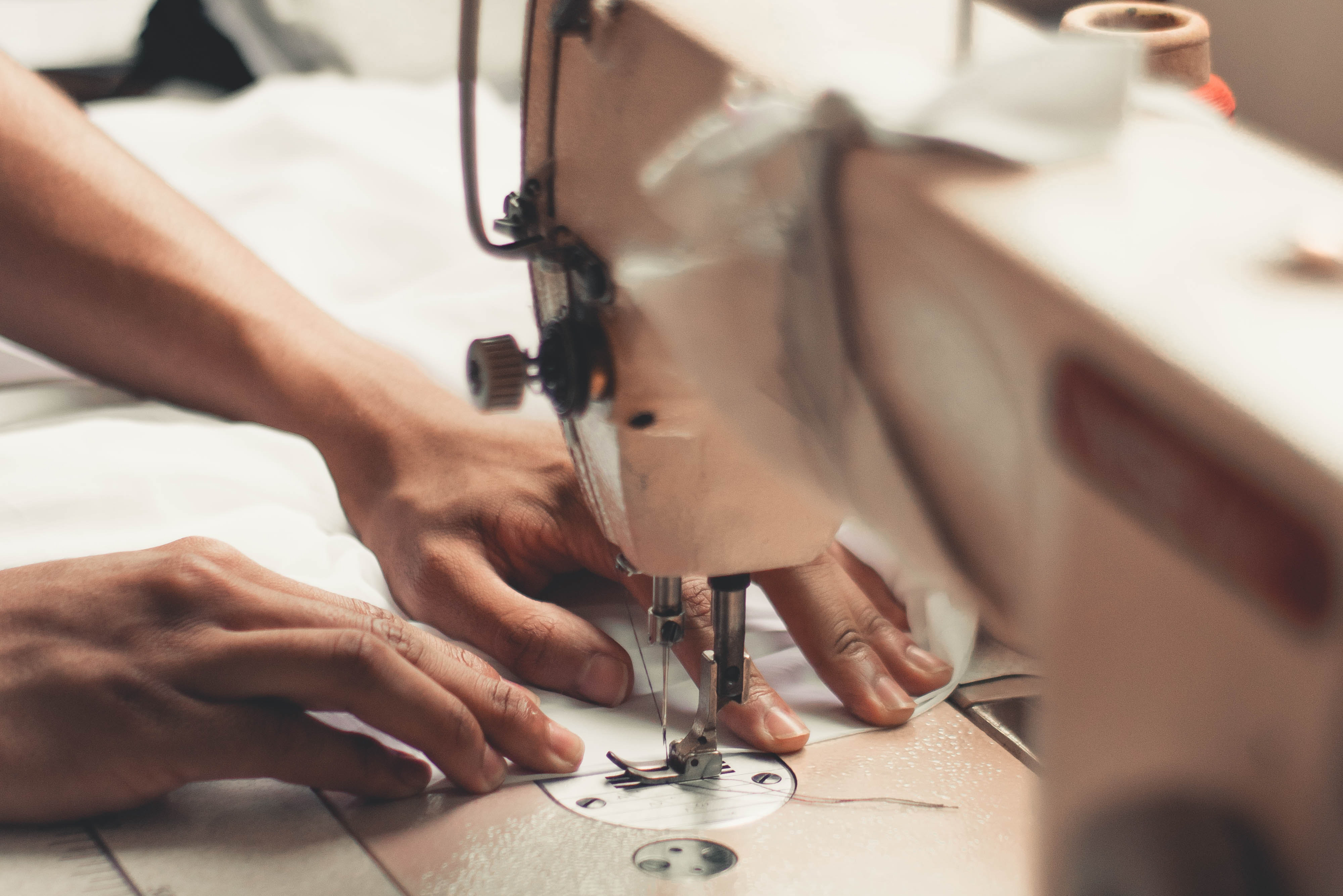 image of hands using a sewing machine