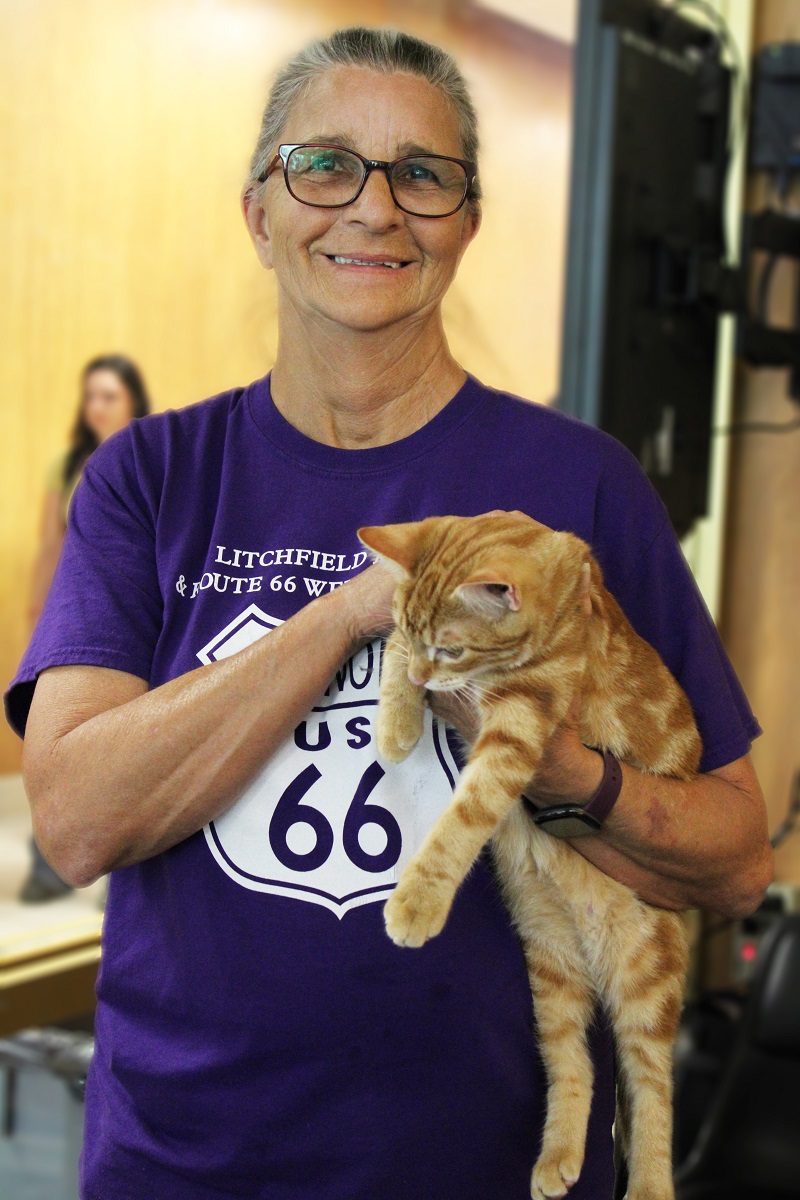 a woman holds a cat